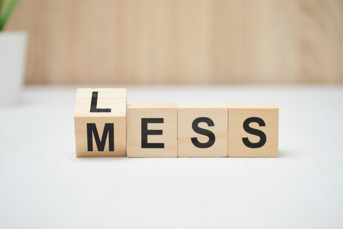 Sustainable decluttering - Feature image from Canva - Image is of wooden blocks that spell out 'less mess'