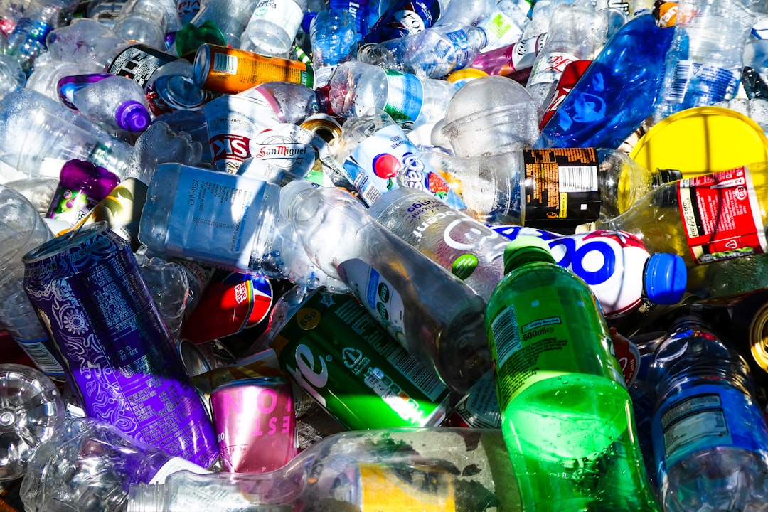 A large pile of discarded plastic bottles and aluminum cans for recycling